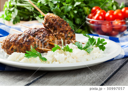 Barbecued kofta with rice on a plate 30997057