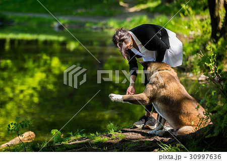 Woman with an American Akita dog 30997636