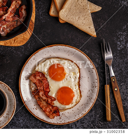 Breakfast with bacon , fried egg, coffee Breakfast with bacon , fried egg, coffee 31002358