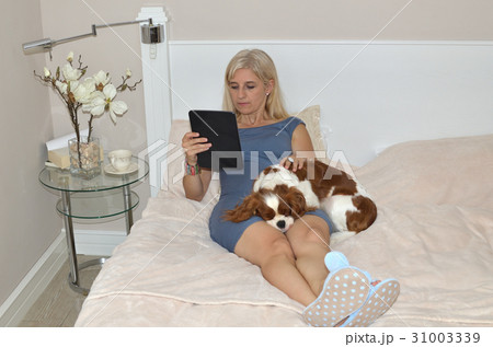 Woman Holding a Tablet Woman Holding a Tablet 31003339