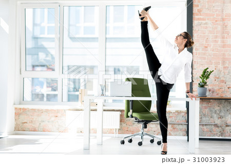 Outgoing woman stretching legs at job Outgoing woman stretching legs at job 31003923