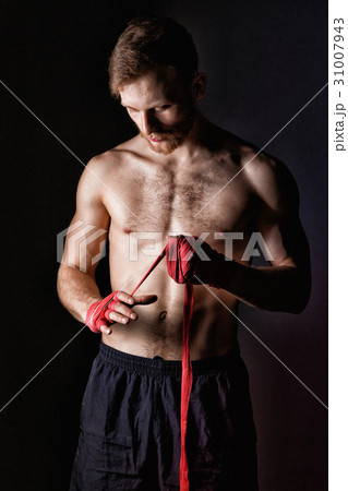 Blond sportsman with boxing bandages Blond sportsman with boxing bandages 31007943