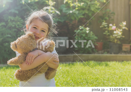 Little girl hugging teddy Little girl hugging teddy 31008543