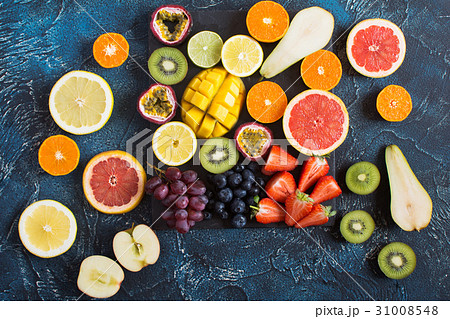 Raw fruits platter on the dark blue table 31008548