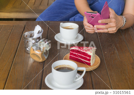 Hand holding mobile phone and a cup of coffee Hand holding mobile phone and a cup of coffee 31015561