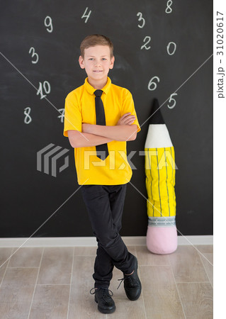 Cute handsome school boy in yellow t-shirt tie and 31020617