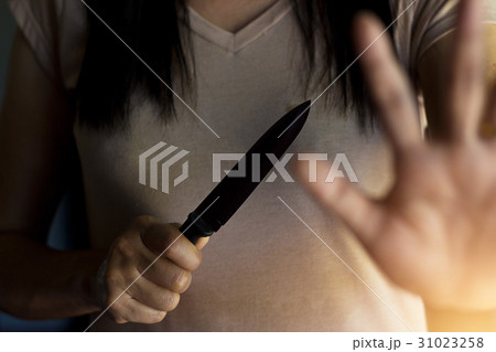 Woman holding knife, defending from attact Woman holding knife, defending from attact 31023258
