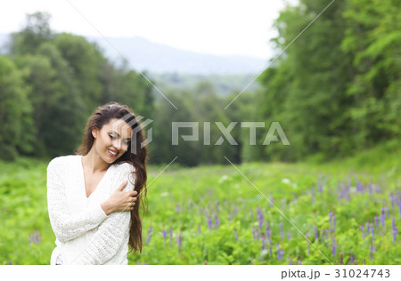Happy pretty brunette woman in flower field 31024743