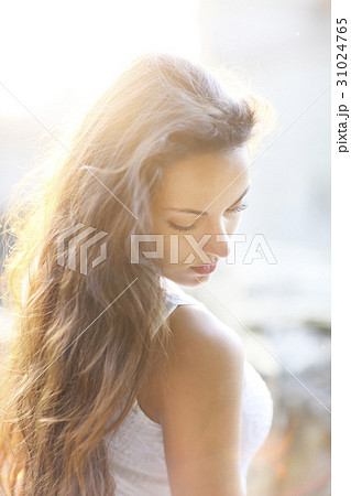 Young beautiful woman at summer sunset 31024765