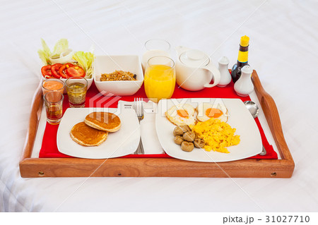 Breakfast set in tray on bed Breakfast set in tray on bed 31027710
