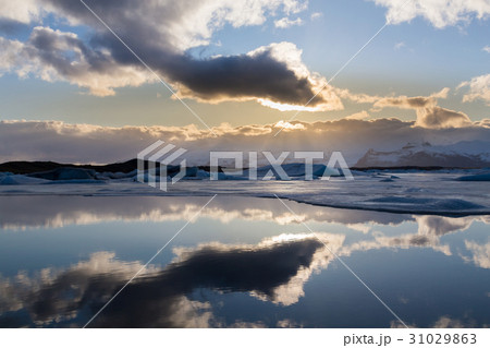 Reflection winter lagoon with sun behind Reflection winter lagoon with sun behind 31029863