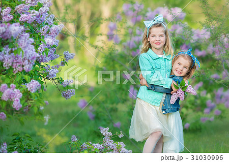 two cute smiling girls sisters lovely together on 31030996