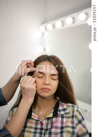 Brow master working with woman eyebrows 31034157