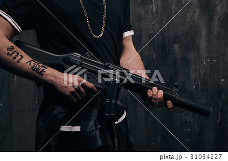 Unrecognizable killer with sniper rifle closeup Unrecognizable killer with sniper rifle closeup 31034227