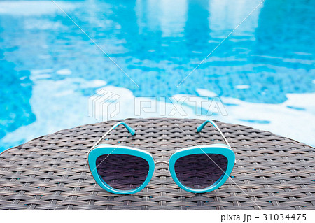 Summertime sunglasses relax near swimming pool 31034475