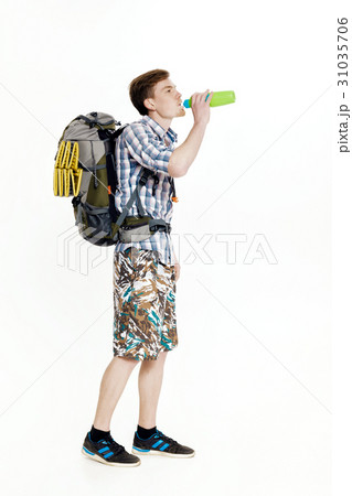 Young tourist with  backpack drinking water o 31035706
