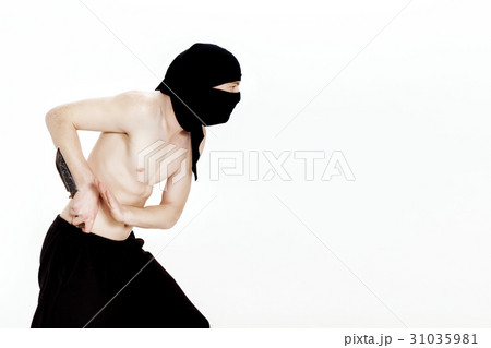 ninja man holds knife and is ready to attack on 31035981