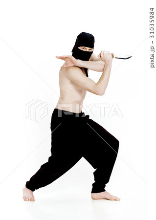 ninja man holds knife and is ready to attack on 31035984