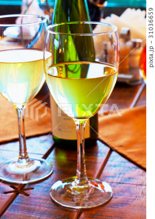 Two goblets with white wine on restaurant table 31036659
