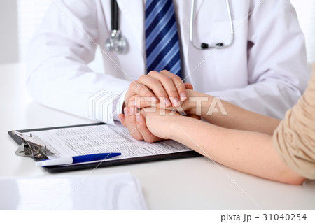 Hand of doctor reassuring her female patien Hand of doctor reassuring her female patien 31040254
