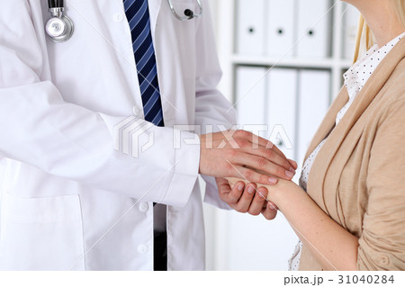 Hand of doctor  reassuring her female patien 31040284