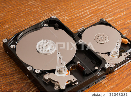 Disassembled hard drives on a wooden surface Disassembled hard drives on a wooden surface 31048081