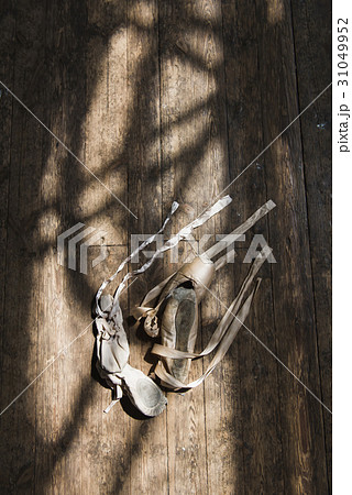 Old ballet shoes on old wooden floor. 31049952