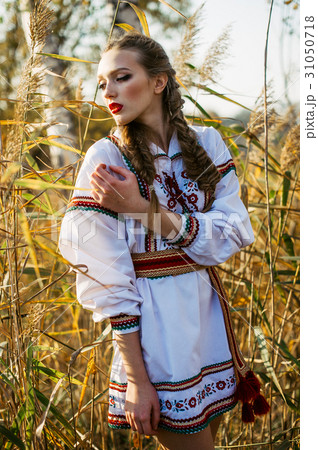 Young girl on the summer field in national clothes Young girl on the summer field in national clothes 31050718