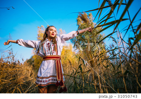 Young girl on the summer field in national clothes 31050743
