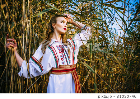 Young girl on the summer field in national clothes 31050746