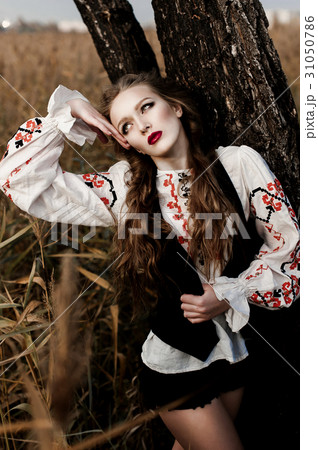 Young girl on the summer field in national clothes Young girl on the summer field in national clothes 31050786
