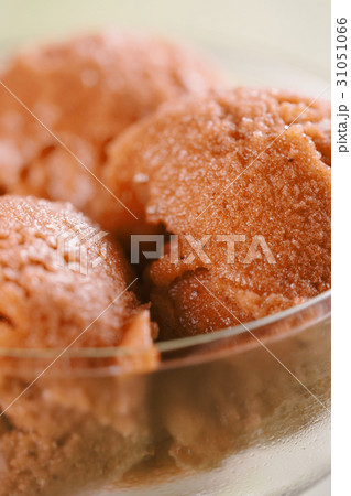 orange sorbet ice cream in glass bowl 31051066