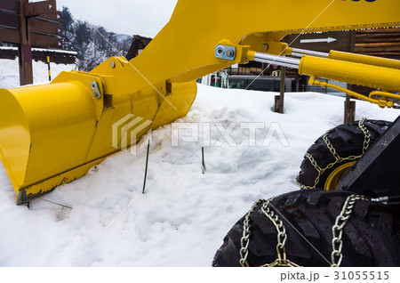 Yellow snowplow truck cleared snow-covered road Yellow snowplow truck cleared snow-covered road 31055515