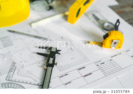 Construction plans with helmet and drawing tools on blueprints . Construction plans with helmet and drawing tools on blueprints . 31055784