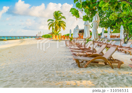 Beach chairs with umbrella at Maldives island, white sandy beach and sea . 31056531