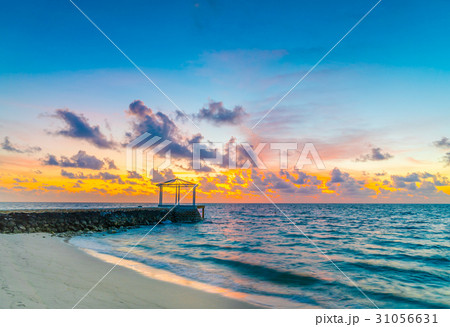 Beautiful sunset with sky over calm sea in tropical Maldives island . Beautiful sunset with sky over calm sea in tropical Maldives island . 31056631