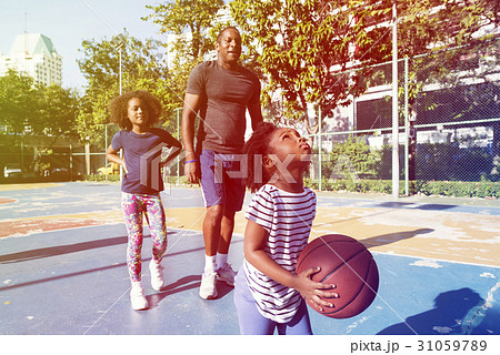 Little african girl playing basketball with family 31059789