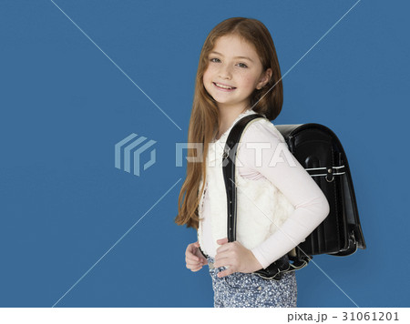 Young freckled girl carrying a backpack smiling portrait Young freckled girl carrying a backpack smiling portrait 31061201