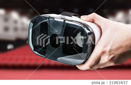 Hand holding virtual reality glasses in the cinema 31063637