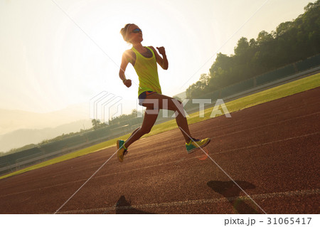fitness woman runner running on stadium track 31065417