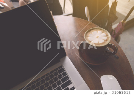 Coffee cup with laptop on table in coffee shop 31065612