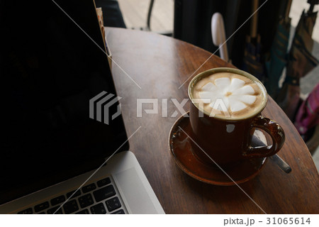 Coffee cup with laptop on table in coffee shop 31065614