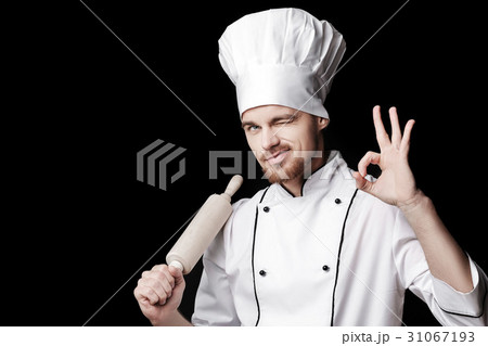 Young bearded man chef In white uniform holds Young bearded man chef In white uniform holds 31067193