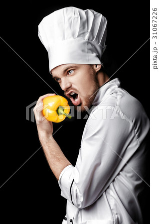 Young bearded man chef In white uniform holds Young bearded man chef In white uniform holds 31067226