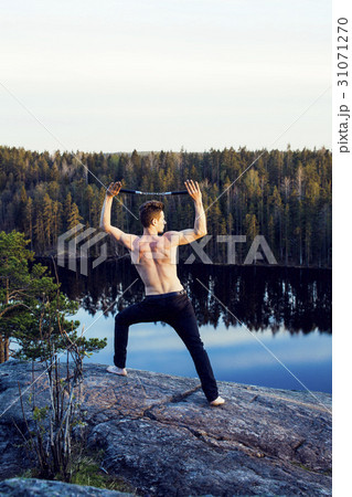 middle age man doing sport yoga on the top of the 31071270