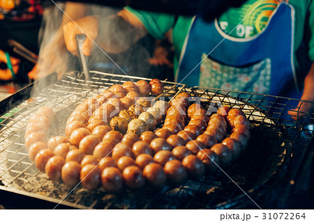 Man cooks meatballs on the grill 31072264