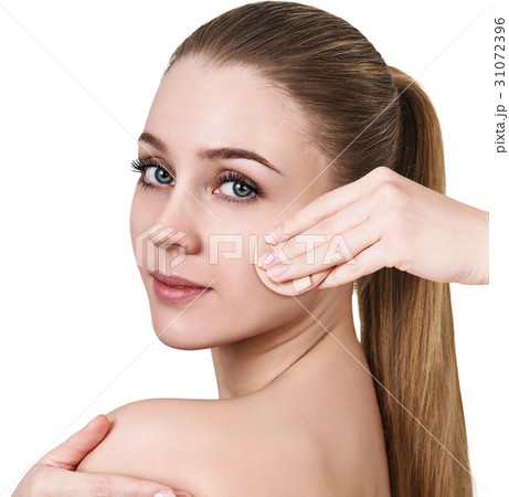 Young woman using cosmetics sponge. Young woman using cosmetics sponge. 31072396