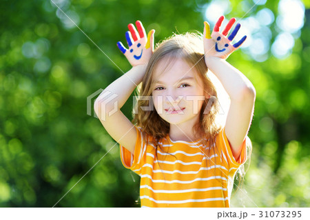 Adorable little girl with her hands painted Adorable little girl with her hands painted 31073295