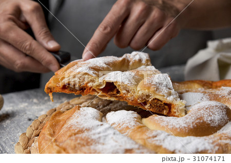 man serving ensaimada typical of Mallorca, Spain 31074171