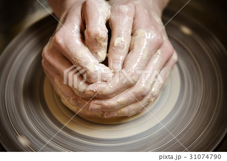 Master potter folded together hands sculpts a clay Master potter folded together hands sculpts a clay 31074790
